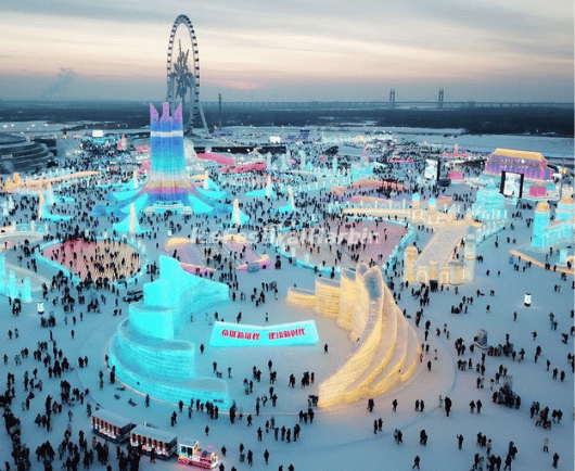 a large crowd of people in a large area with lights